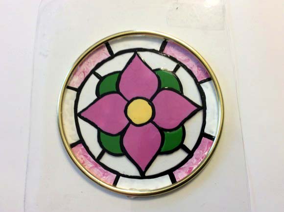 Faux Stained Glass Suncatcher - Use clear plastic containers to create faux stained glass suncatchers! They are as easy to make as they are pretty to look at.