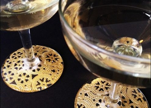 Make gilded lace champagne glasses (via dollarstorecrafts.com)