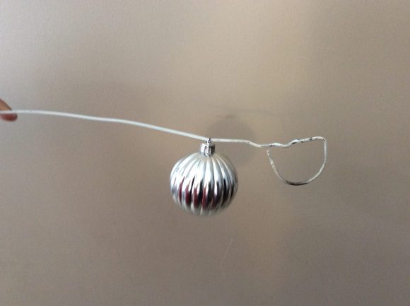 A wreath made out of ornaments has become a classic Christmas decoration. If you've always wanted one, you will be happy and surprised to find out just how easy and cheap it is to create your own! You can even use scratched or damaged ornaments for this project, making it a great way to give new life to old decorations that might otherwise be destined for the trash.