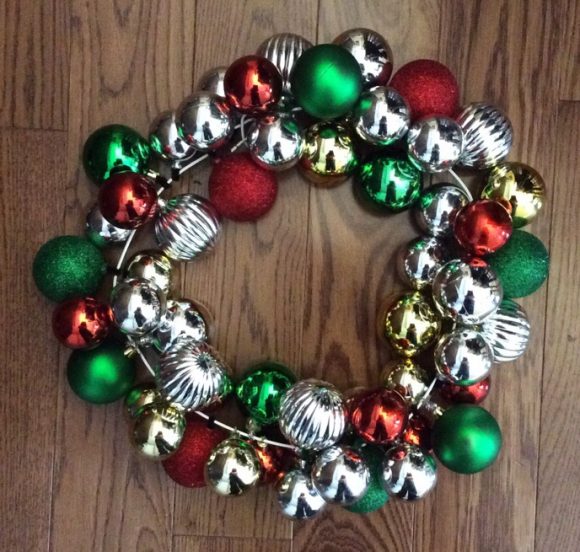 A wreath made out of ornaments has become a classic Christmas decoration. If you've always wanted one, you will be happy and surprised to find out just how easy and cheap it is to create your own! You can even use scratched or damaged ornaments for this project, making it a great way to give new life to old decorations that might otherwise be destined for the trash.
