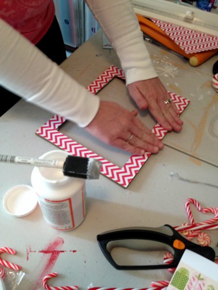Covering a dollar store mirror with pretty scrapbook paper - great project to help me use up my extra paper