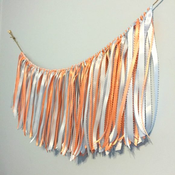 You can use new ribbon to make this fringe garland or bust your stash. The trick is in how you tie the knots.