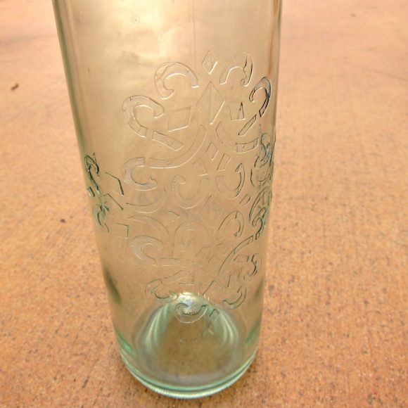 Make a Faux Sea Glass Bottle - Sea glass is still so popular, and it's a beautiful way to decorate your home in the summer.  Rather than buying new decorative accents, you can make your own using a few simple items plus recyclables.  