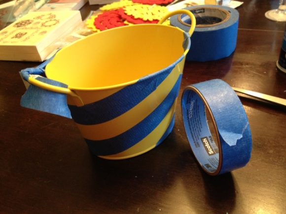 Masking off container to apply gold leaf